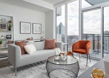 a living room with a view of the city and a couch and a table