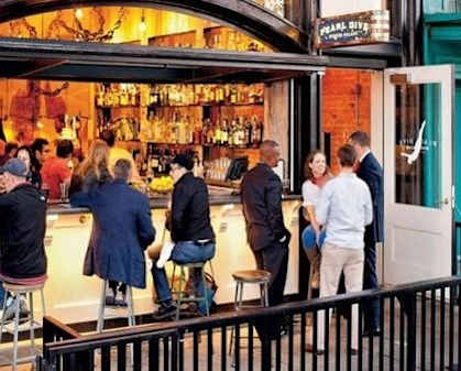 People chatting at a cozy bar near The DeSoto Apartments Building in Washington, DC 20005