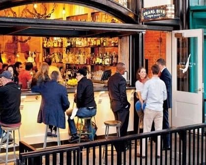 People chatting at a cozy bar near The DeSoto Apartments Building in Washington, DC 20005