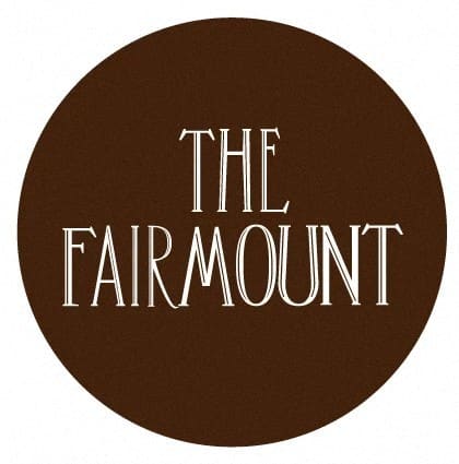 A brown circle with the words "The Fair Mount" written in white.