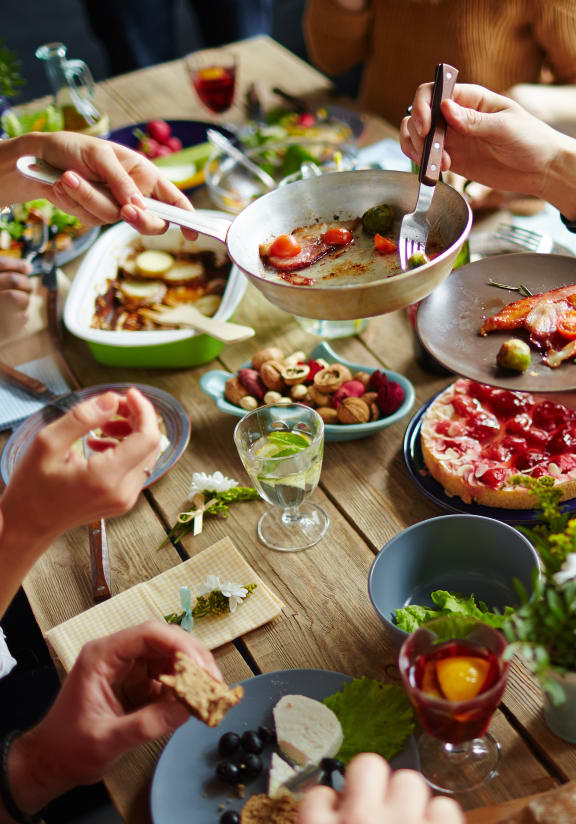 a group of people sitting around a table eating food