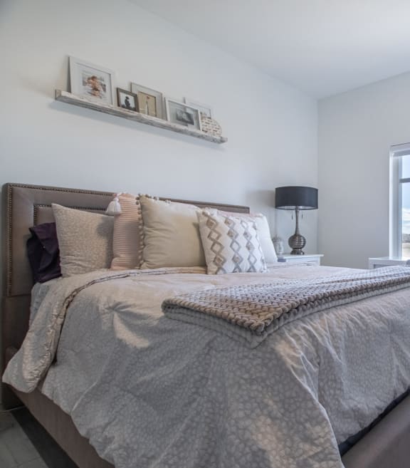 a bedroom with a bed and a window