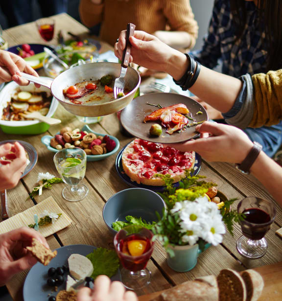 a group of people sitting around a table eating food