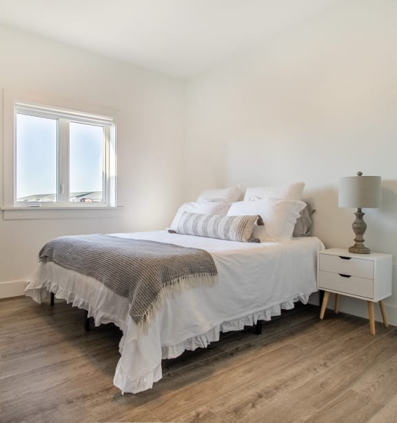 a living room with a dresser and a mirror on the wall