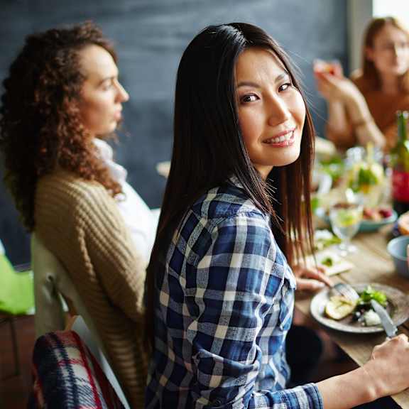 A group of people are sitting around a table enjoying a meal together.at Villa Solera, California, 95122