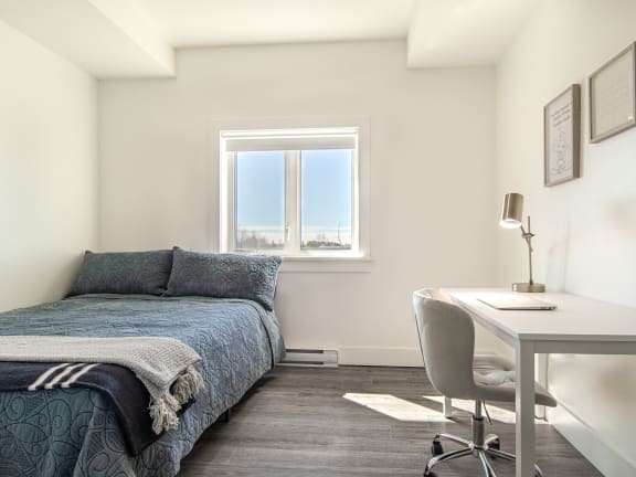 a bedroom with a bed and a window