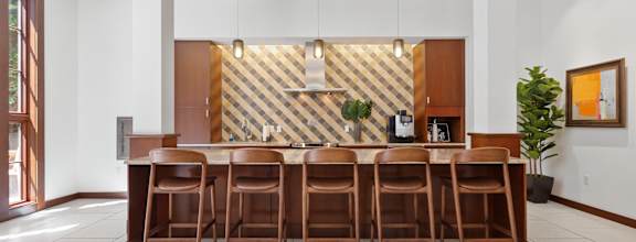 A dining room with a wooden table and chairs.