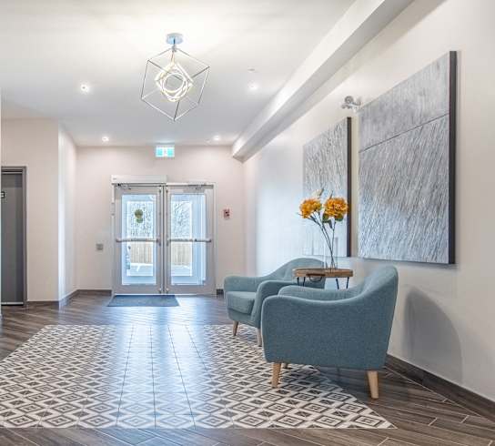 a lobby with couches and chairs and a door