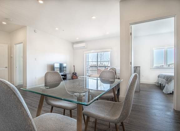 a dining room with a glass table and chairs