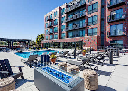 A red building with a pool in front.