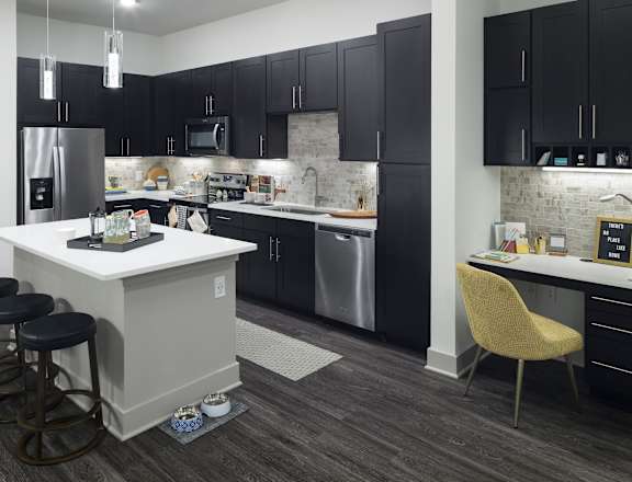 a kitchen with black cabinets and a white counter top