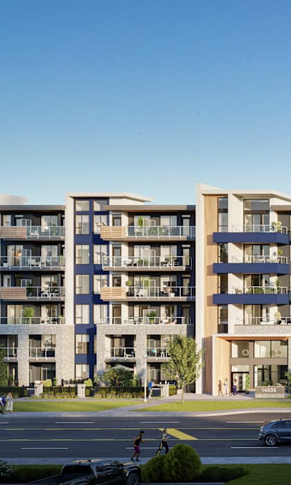 A large apartment complex with cars parked in front.