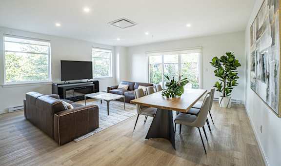 a living room with couches and a table and a television