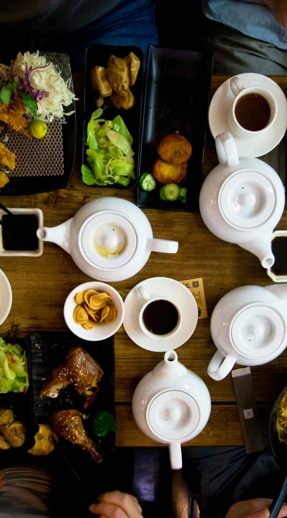 a group of people sitting around a table eating food