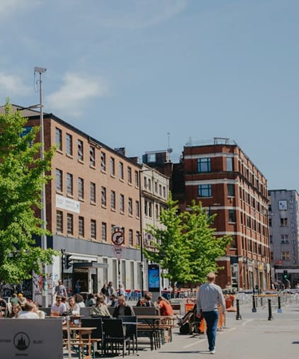 people standing on a sidewalk in front of a building