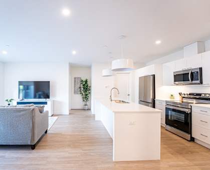 a living room with a kitchen and a dining room