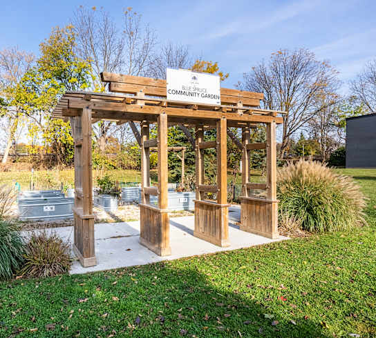 the garden has a pergola with benches and a hot tub