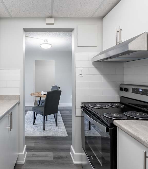 a kitchen with white appliances and white cabinets at Platts Crossing, London, ON