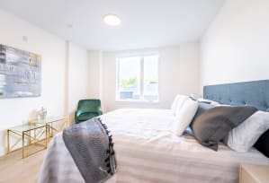 a bedroom with a large bed and a window