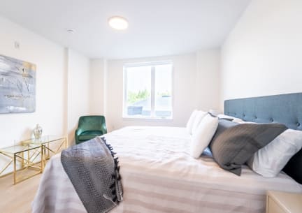 a bedroom with a large bed and a window