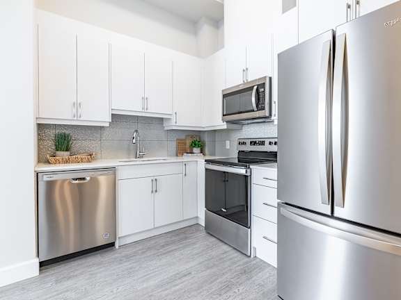 A modern kitchen with a refrigerator on the right.