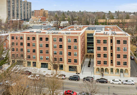 a large brick building with cars parked in front of it