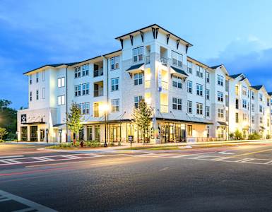 a street view of an apartment building at dusk at The Eddy at Riverview, Smyrna, GA, 30126