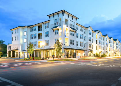 a street view of an apartment building at dusk at The Eddy at Riverview, Smyrna, GA, 30126