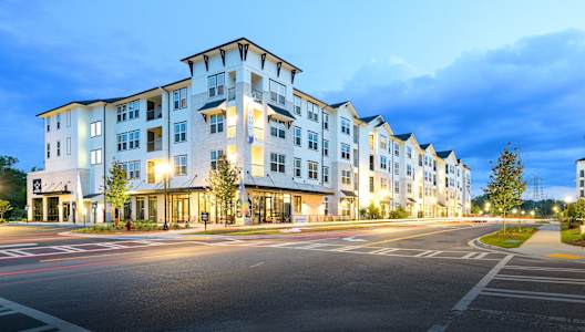 a street view of an apartment building at dusk at The Eddy at Riverview, Smyrna, GA, 30126