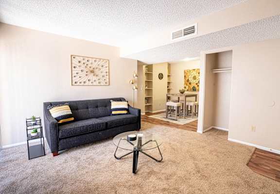 A living room with a grey couch and a coffee table.