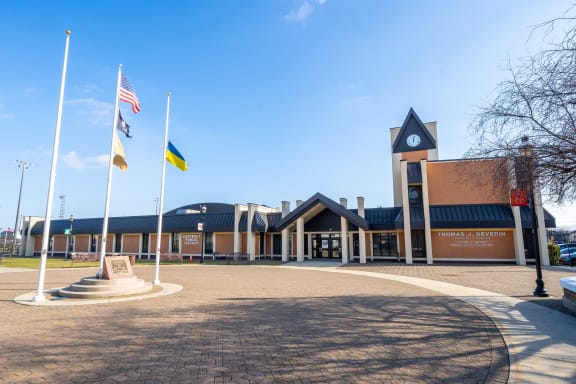 a building with flags and a flagpole in front of it at The Botanic, New Jersey, 07008