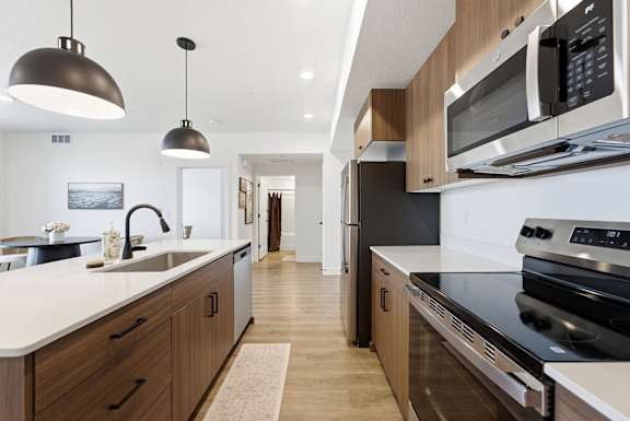 A modern kitchen with a black stove top oven.