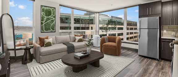 A modern living room with a large window overlooking the city.