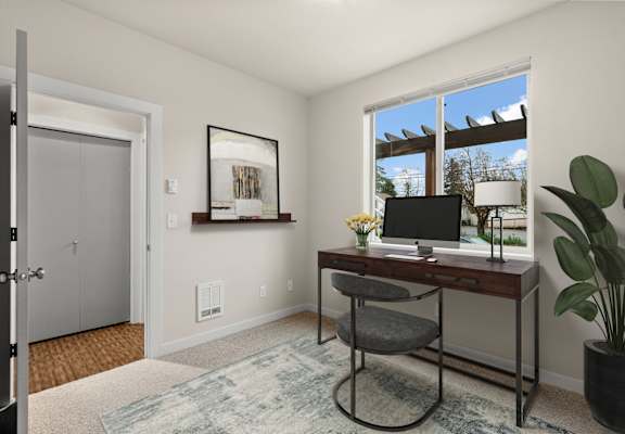 A room with a desk and a chair.