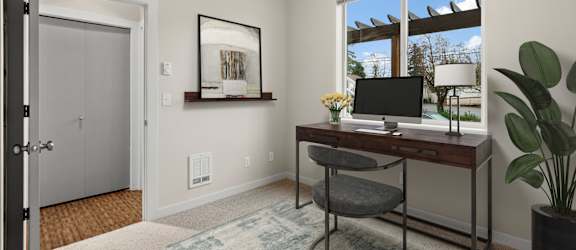 A room with a desk and a chair.