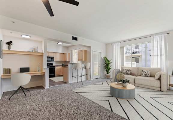 A modern living room with a grey carpet and a white ceiling fan.