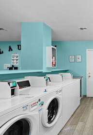 A row of washing machines in a laundromat.