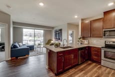 Luxury apartment with dark cabinetry and granite countertops at Ascend at Woodbury MN 55129 new luxury apartments
