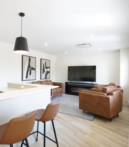 a living room with a bar and a television