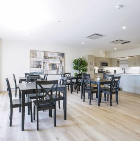 a dining room with a table and chairs and a kitchen
