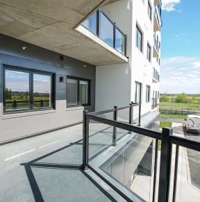 a view of a building from a balcony with a glass railing