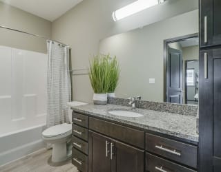 Bathroom with granite countertops at WH Flats new luxury apartments in south Lincoln NE 68516