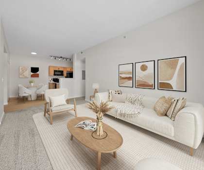 A living room with a white couch, a coffee table, and a fireplace.