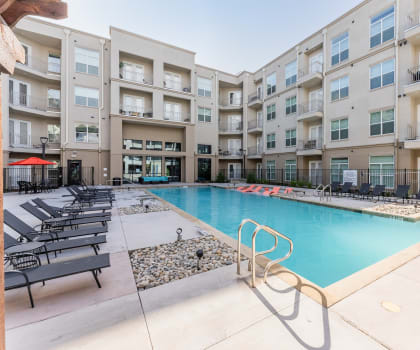 Swimming Pool Area With Shaded Chairs at Residences at 3000 Bardin Road, Grand Prairie