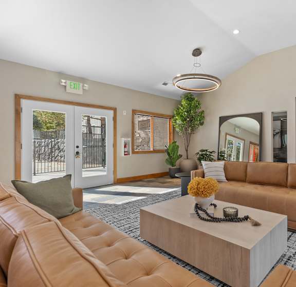 A Living Room With a Brown Leather Couch at ALTITUDE BY VINTAGE, Nevada