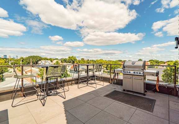 Rooftop patio and outdoor firepit at The Central apartments near downtown Minneapolis MN 55408