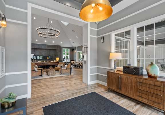 the lobby of a home with large glass windows and a reception desk
