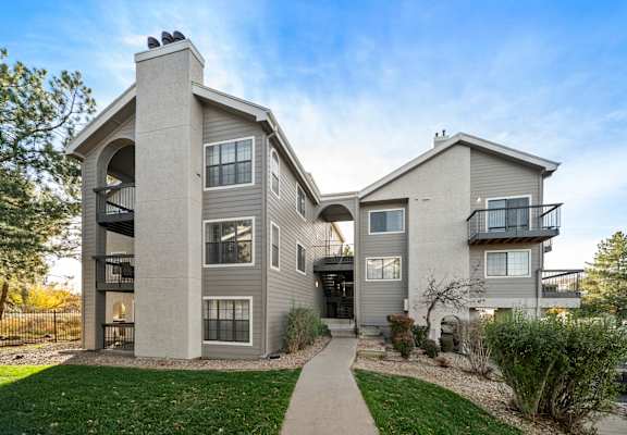 A modern two-story house with a balcony on the second floor.