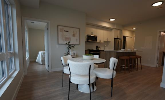 A dining room with a table and chairs.