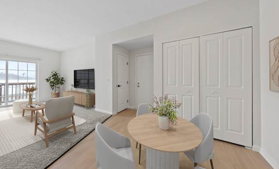 A modern dining room with a wooden table and grey chairs.